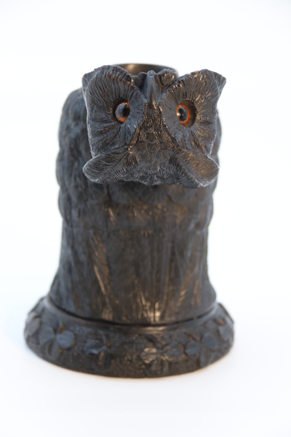 A hand-carved dark oak inkstand crafted in the likeness of an owl with glass eyes and a brass tether, resting on a carved base with shamrock details. View XIV
