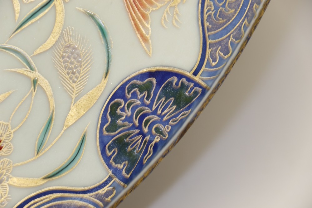 A circular hand-painted Japanese Imari porcelain charger featuring cobalt blue, iron red, and gilt decorative panels depicting birds, goldfish, and botanical motifs. View VII