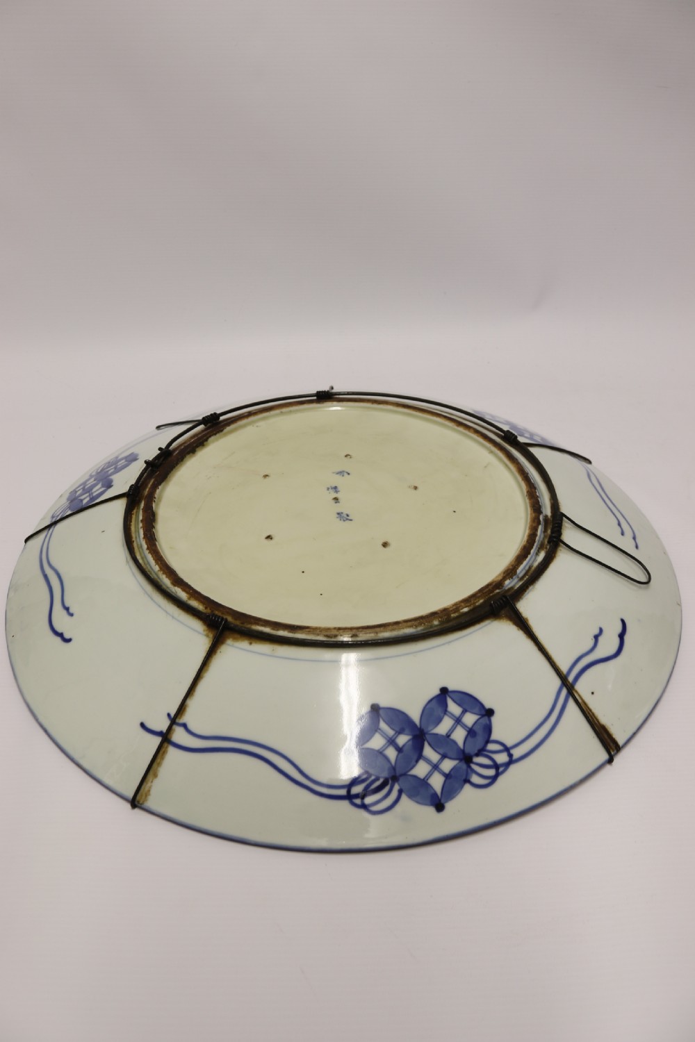 A circular hand-painted Japanese Imari porcelain charger featuring cobalt blue, iron red, and gilt decorative panels depicting birds, goldfish, and botanical motifs. View XIV