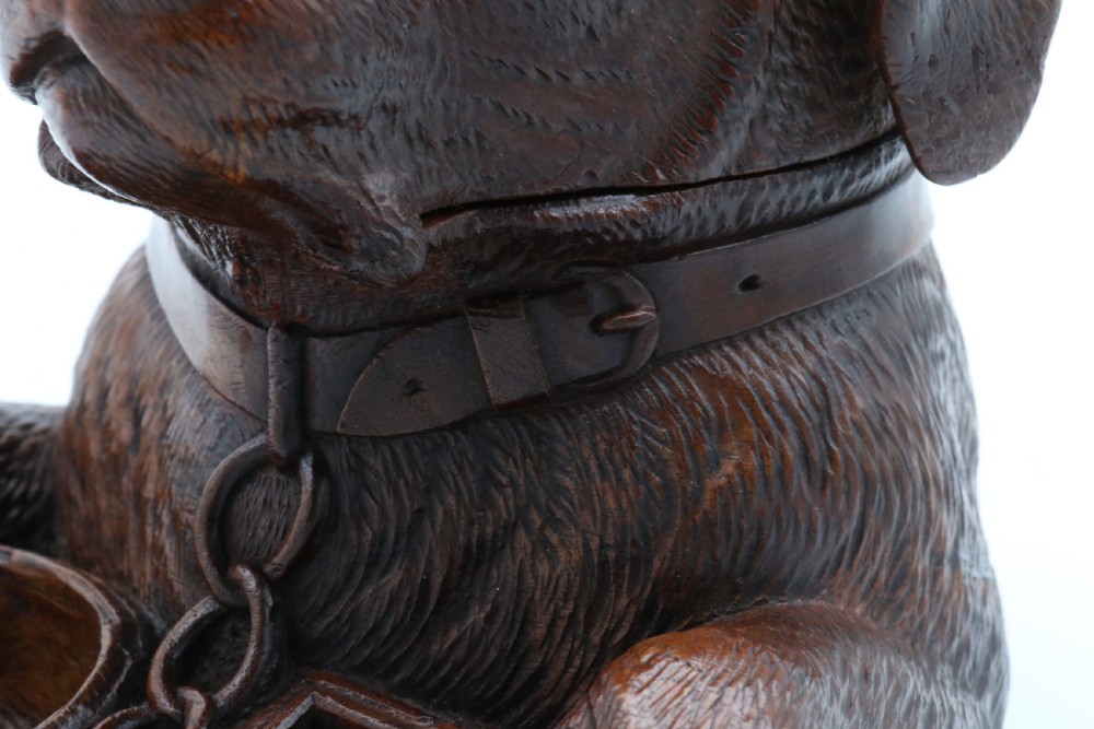 A 19th-century carved wooden tobacco box formed as a dog head with glass eyes and a hinged lid, set on a base with carved trays. View XIV