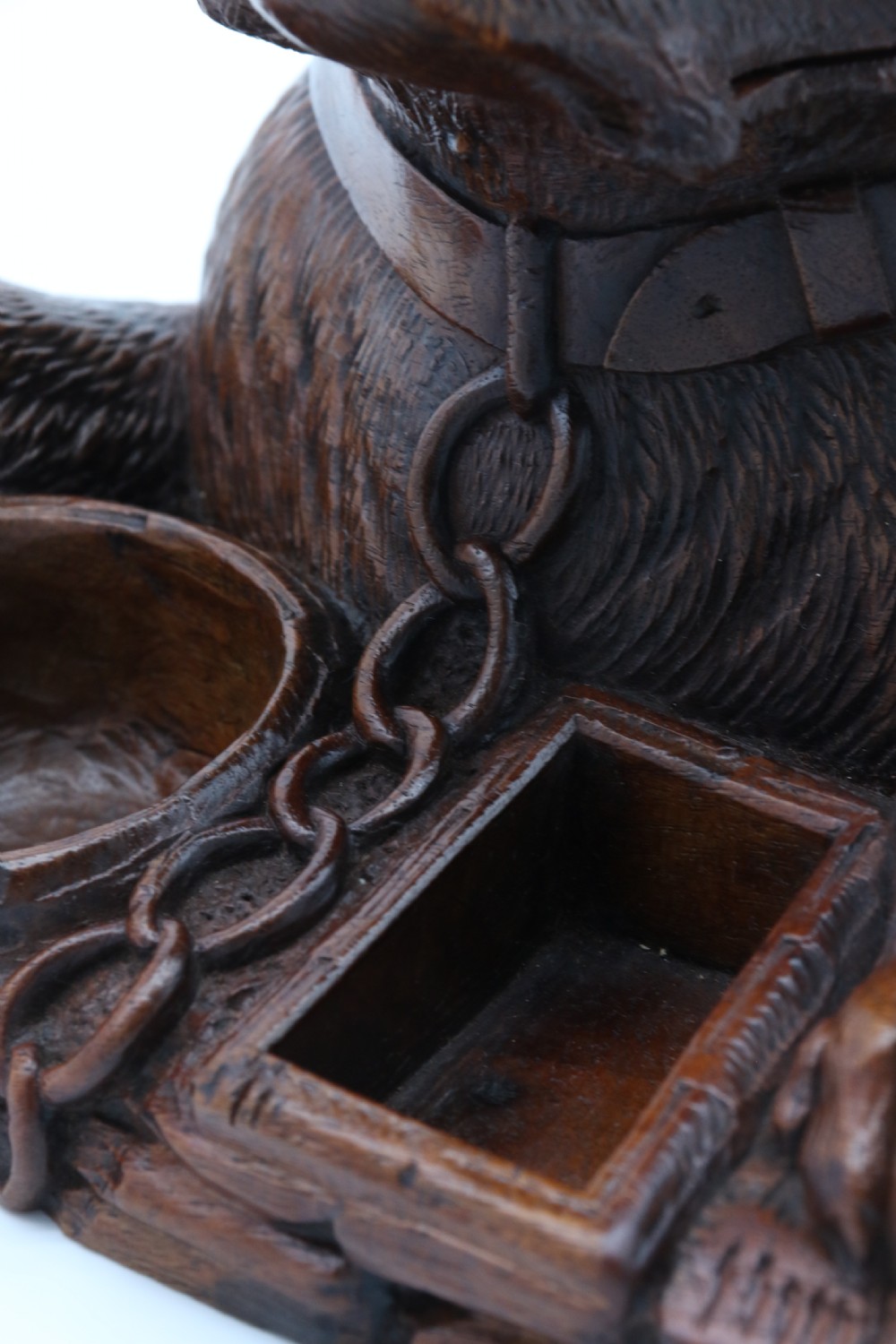 A 19th-century carved wooden tobacco box formed as a dog head with glass eyes and a hinged lid, set on a base with carved trays. View XV