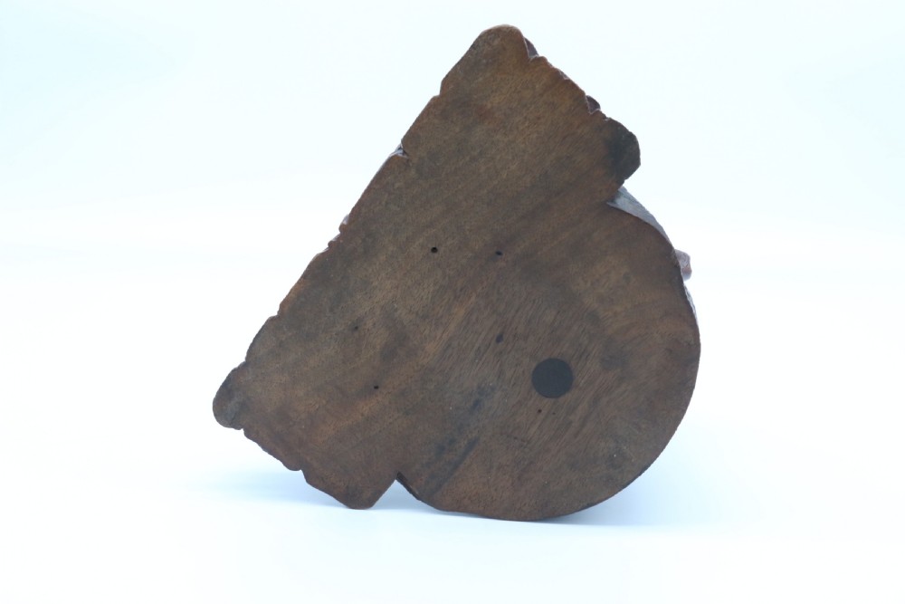 A 19th-century carved wooden tobacco box formed as a dog head with glass eyes and a hinged lid, set on a base with carved trays. View XXII