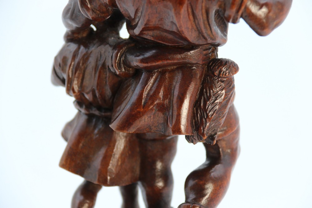 A hand-carved dark walnut wood sculpture depicting William Tell holding a crossbow alongside his son on a base carved with the date 1307. View XVI