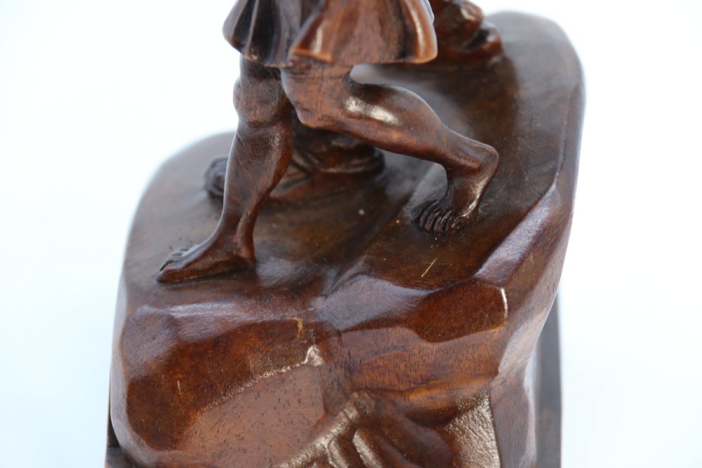 A hand-carved dark walnut wood sculpture depicting William Tell holding a crossbow alongside his son on a base carved with the date 1307. View XVIII