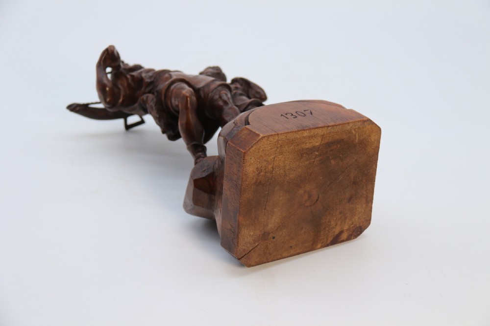 A hand-carved dark walnut wood sculpture depicting William Tell holding a crossbow alongside his son on a base carved with the date 1307. View XIX