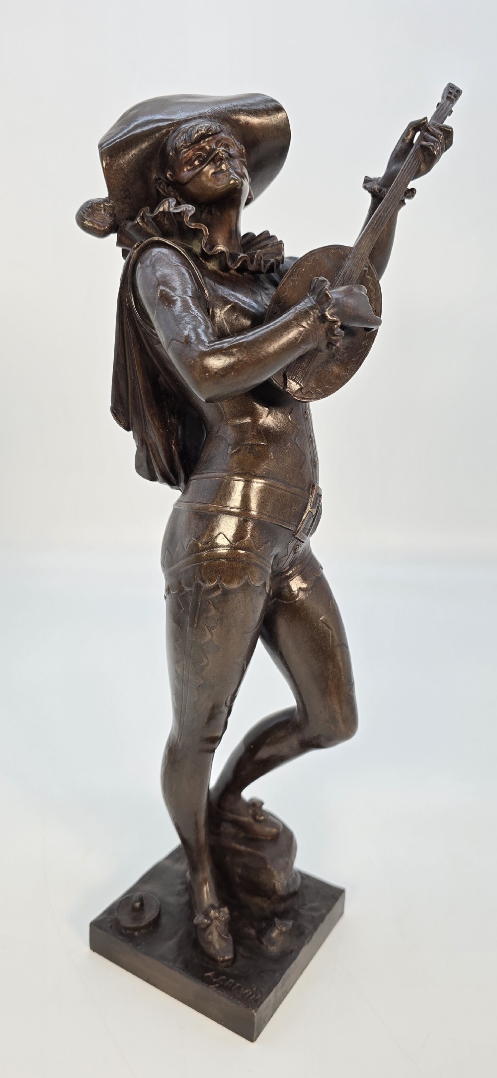 A pair of late 19th-century bronze statuettes depicting theatrical figures playing stringed musical instruments on square bases. View XX