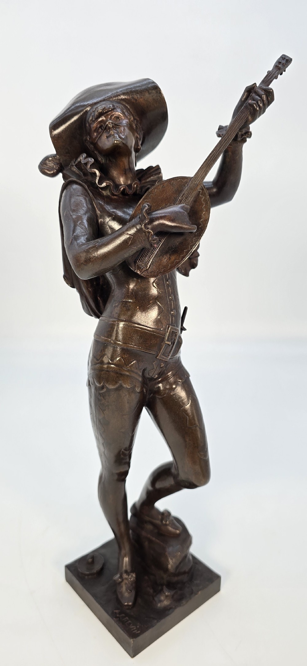 A pair of late 19th-century bronze statuettes depicting theatrical figures playing stringed musical instruments on square bases. View XXII