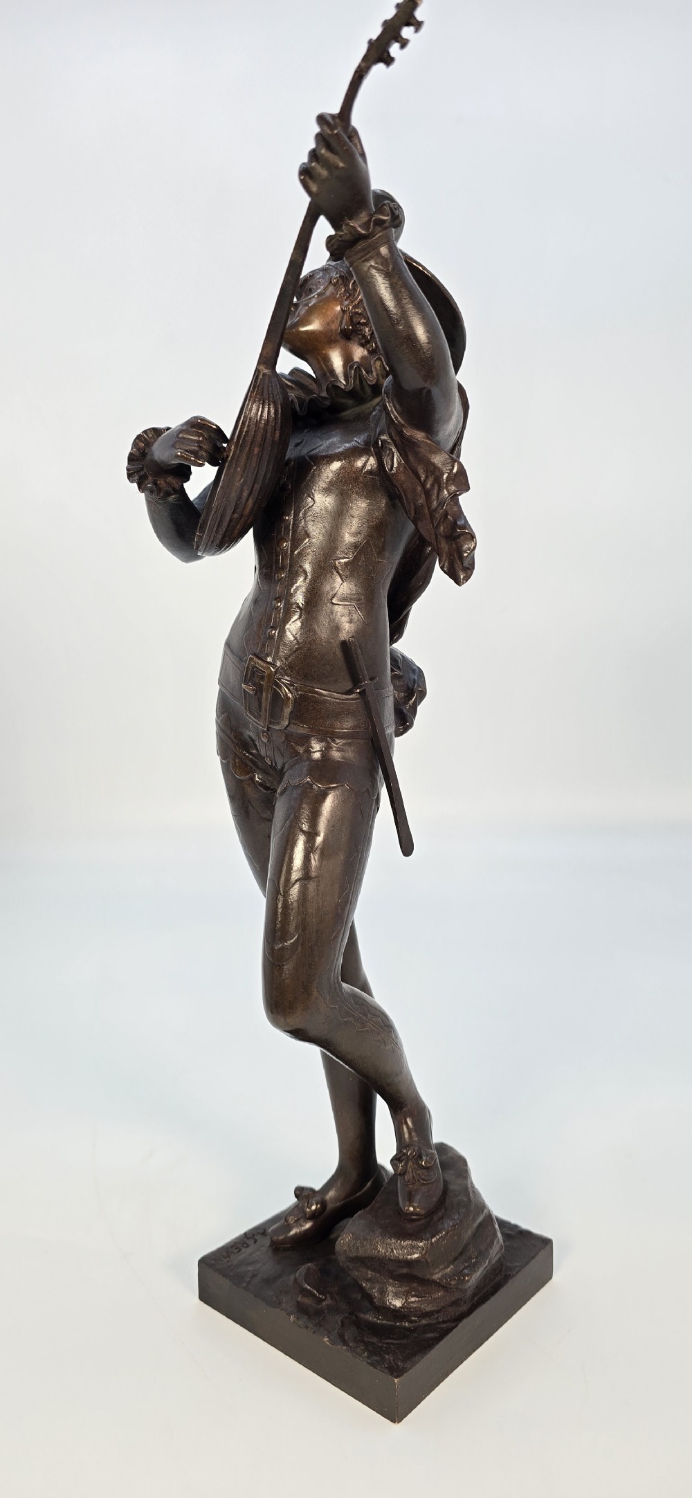 A pair of late 19th-century bronze statuettes depicting theatrical figures playing stringed musical instruments on square bases. View XXVI