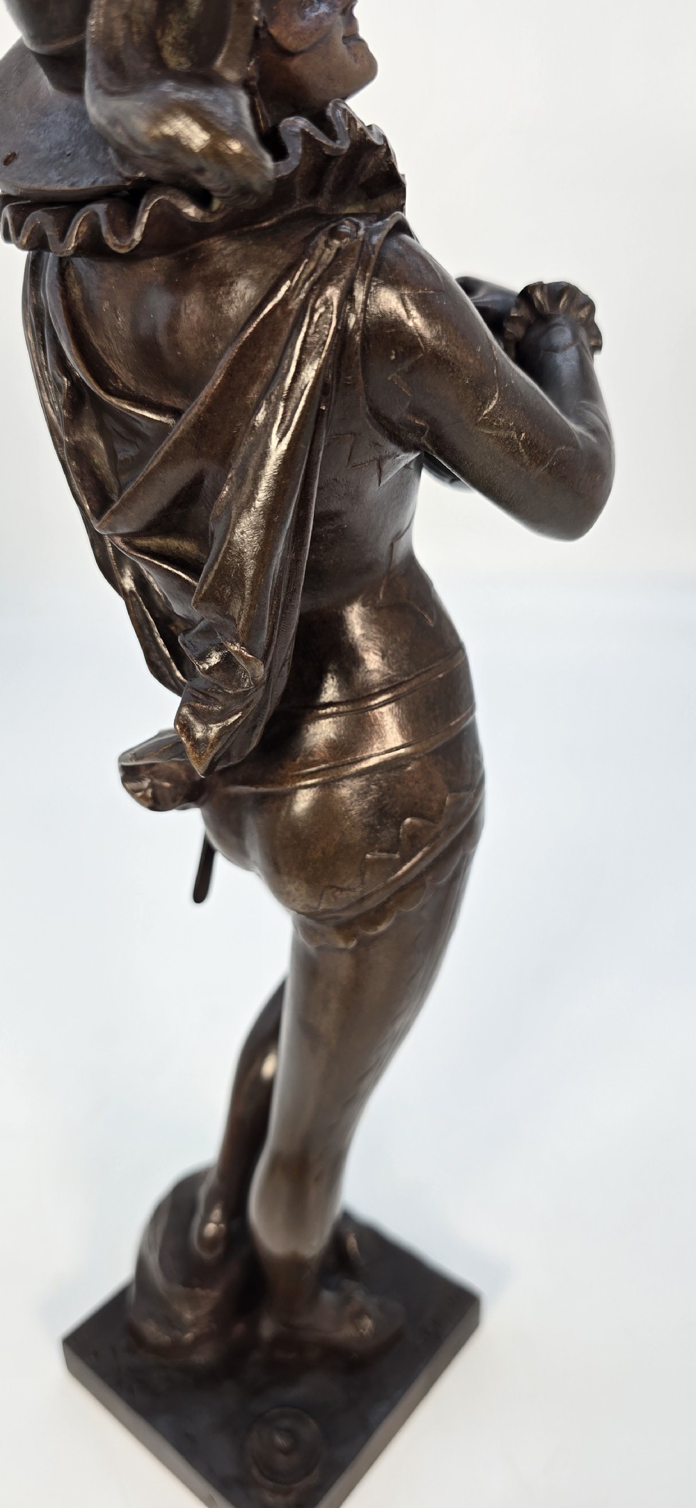 A pair of late 19th-century bronze statuettes depicting theatrical figures playing stringed musical instruments on square bases. View XXVIII