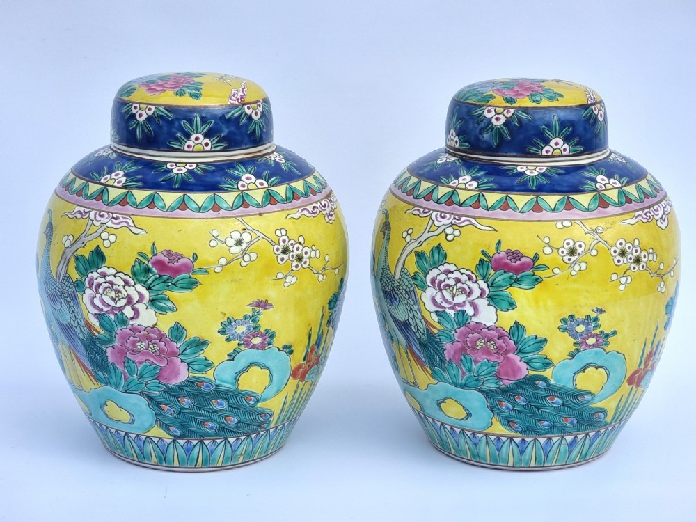A matching pair of yellow porcelain ginger jars featuring hand-painted blue and turquoise phoenixes among peonies and floral branches, topped with deep blue decorated lids. View III