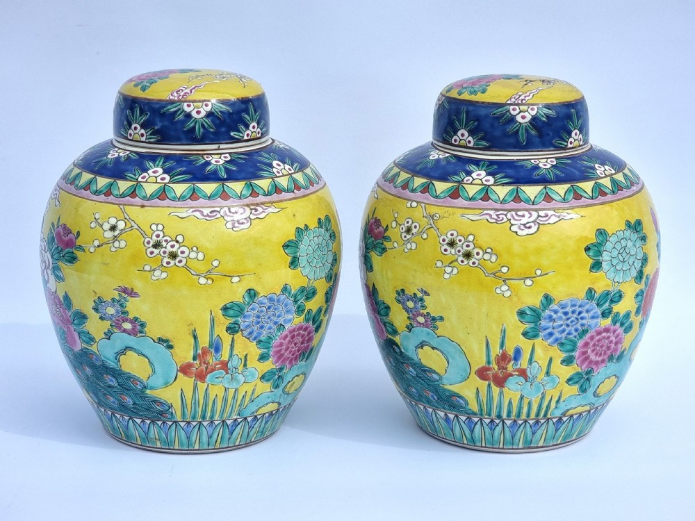 A matching pair of yellow porcelain ginger jars featuring hand-painted blue and turquoise phoenixes among peonies and floral branches, topped with deep blue decorated lids. View IV