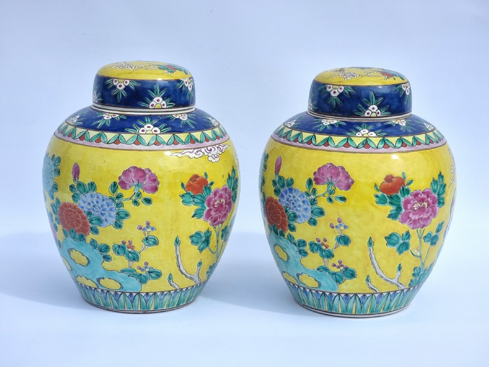 A matching pair of yellow porcelain ginger jars featuring hand-painted blue and turquoise phoenixes among peonies and floral branches, topped with deep blue decorated lids. View VII