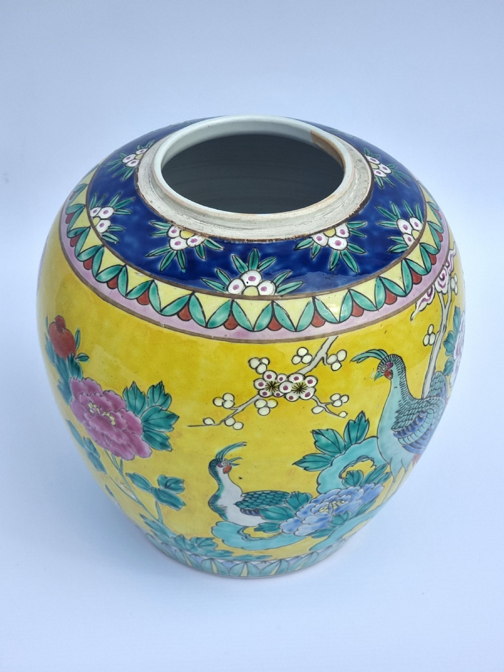 A matching pair of yellow porcelain ginger jars featuring hand-painted blue and turquoise phoenixes among peonies and floral branches, topped with deep blue decorated lids. View XI