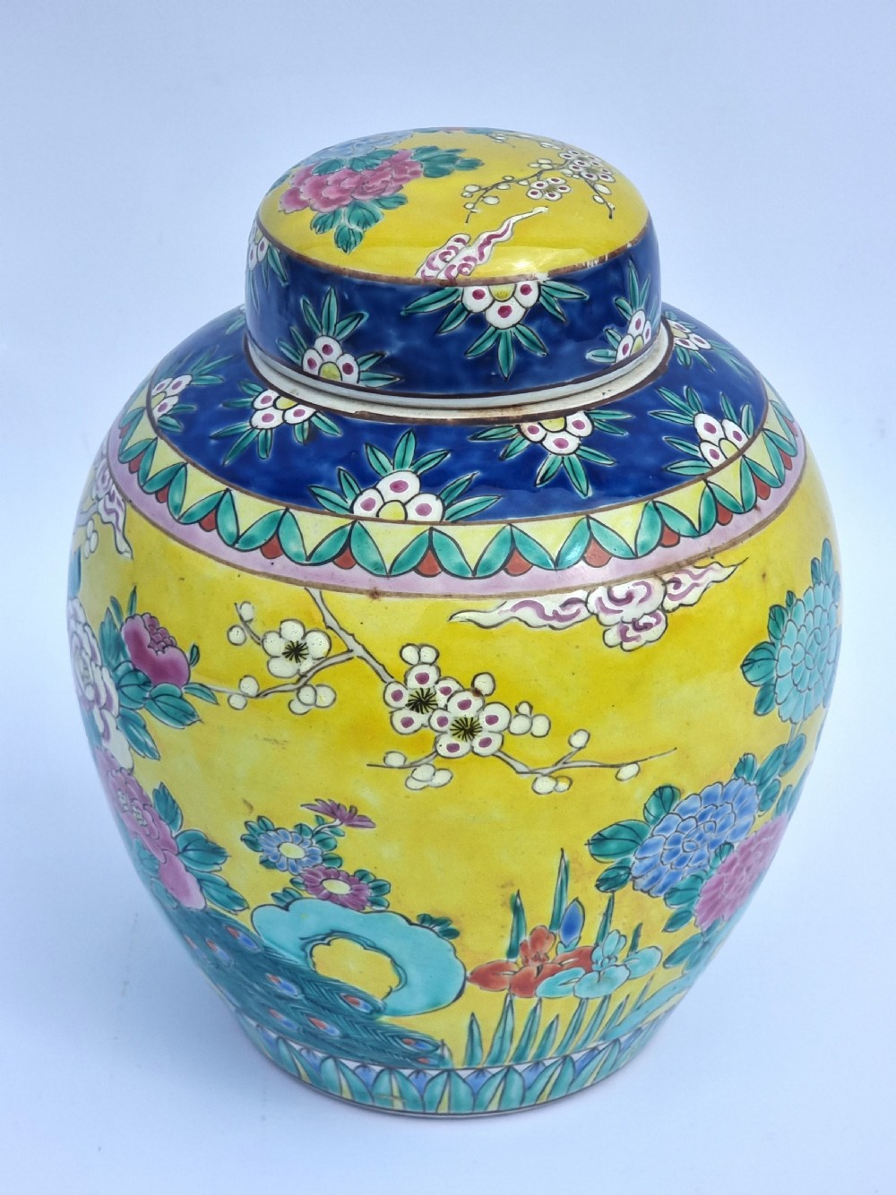 A matching pair of yellow porcelain ginger jars featuring hand-painted blue and turquoise phoenixes among peonies and floral branches, topped with deep blue decorated lids. View XXV