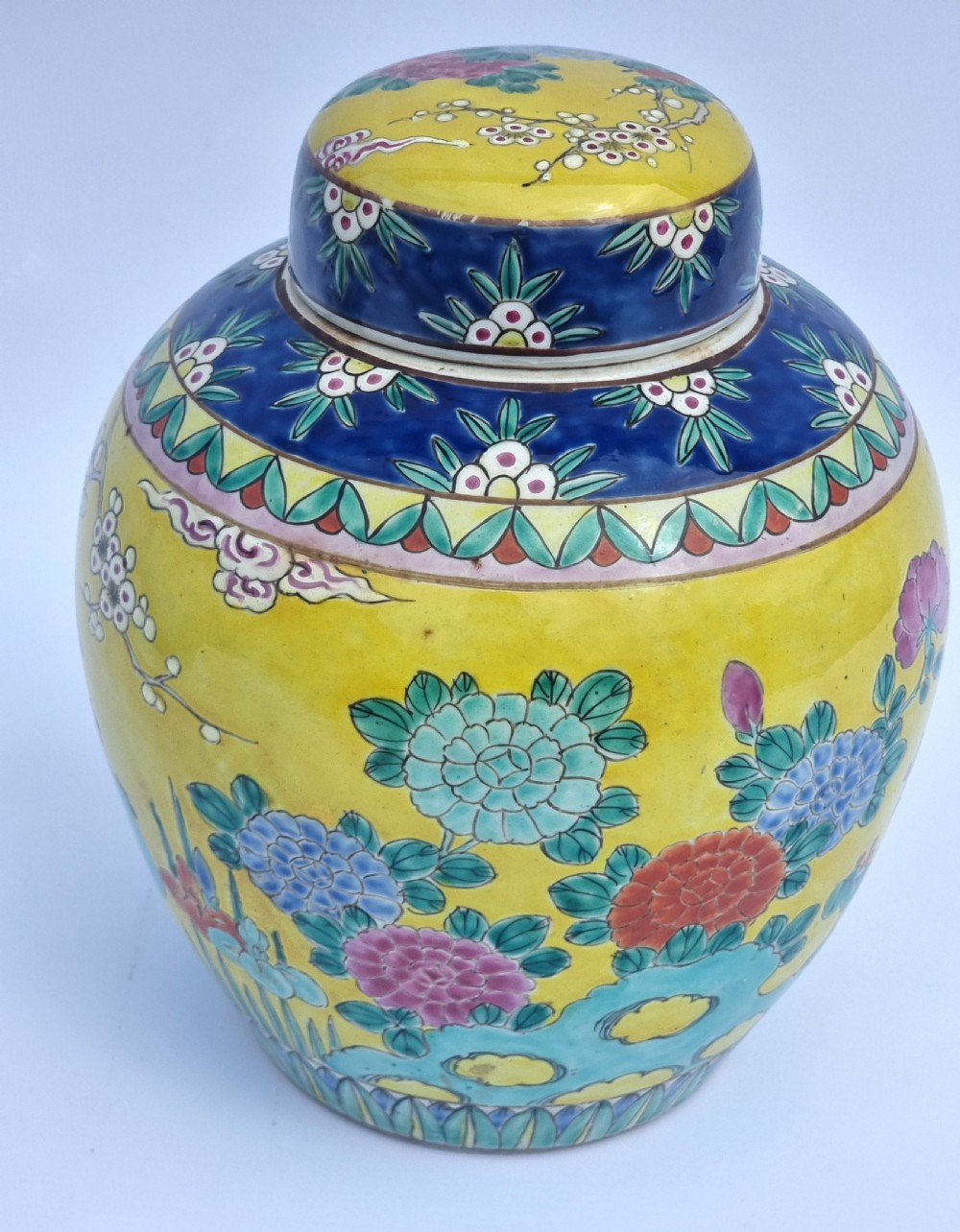 A matching pair of yellow porcelain ginger jars featuring hand-painted blue and turquoise phoenixes among peonies and floral branches, topped with deep blue decorated lids. View XXVI