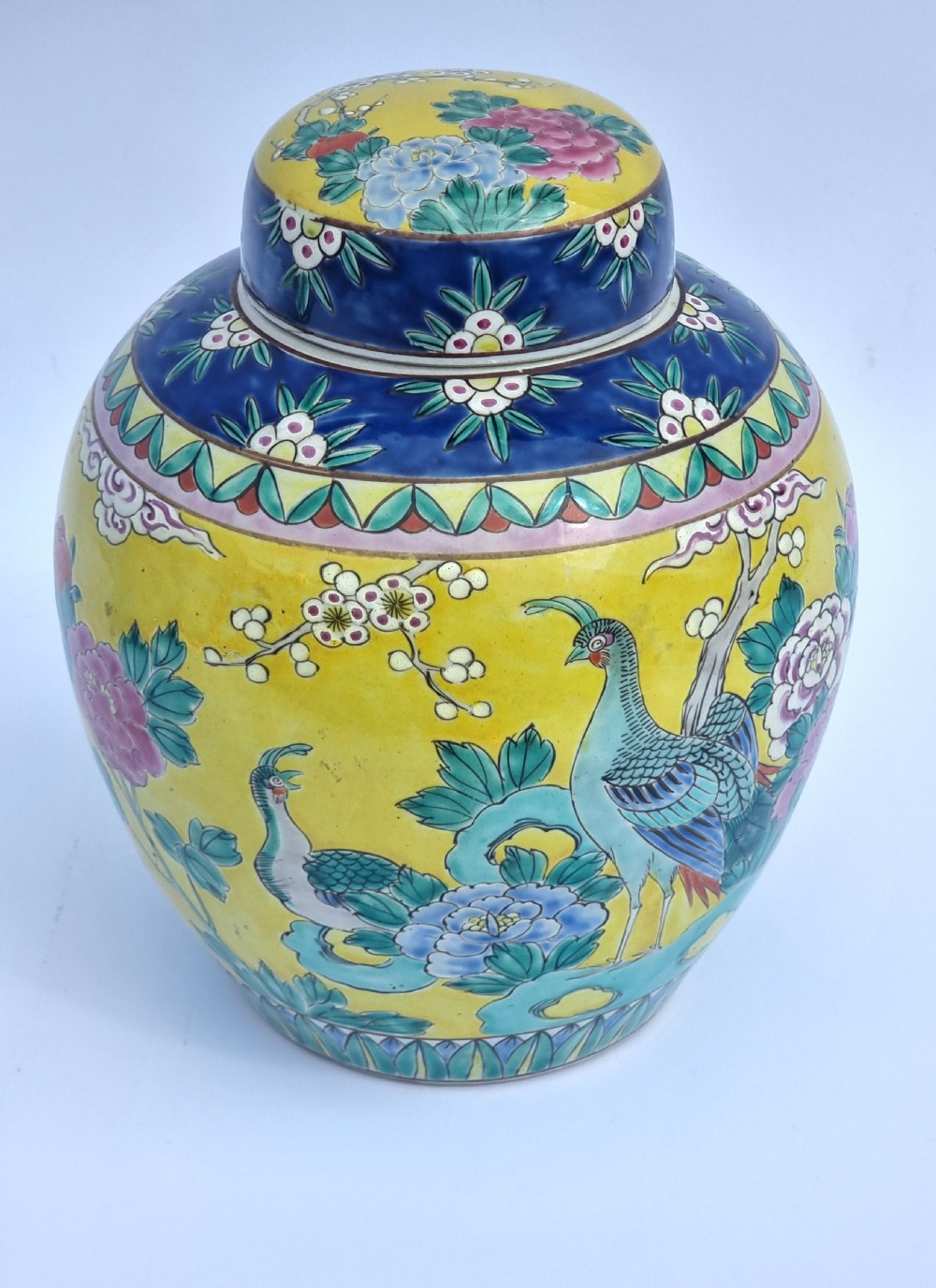 A matching pair of yellow porcelain ginger jars featuring hand-painted blue and turquoise phoenixes among peonies and floral branches, topped with deep blue decorated lids. View XXIX