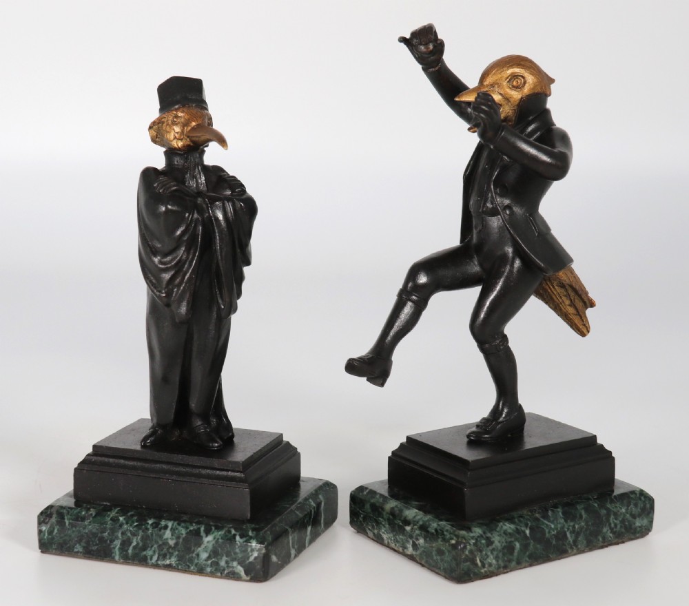 A pair of patinated and parcel-gilt bronze figures depicting anthropomorphic birds in nineteenth-century attire mounted on green marble bases. View II