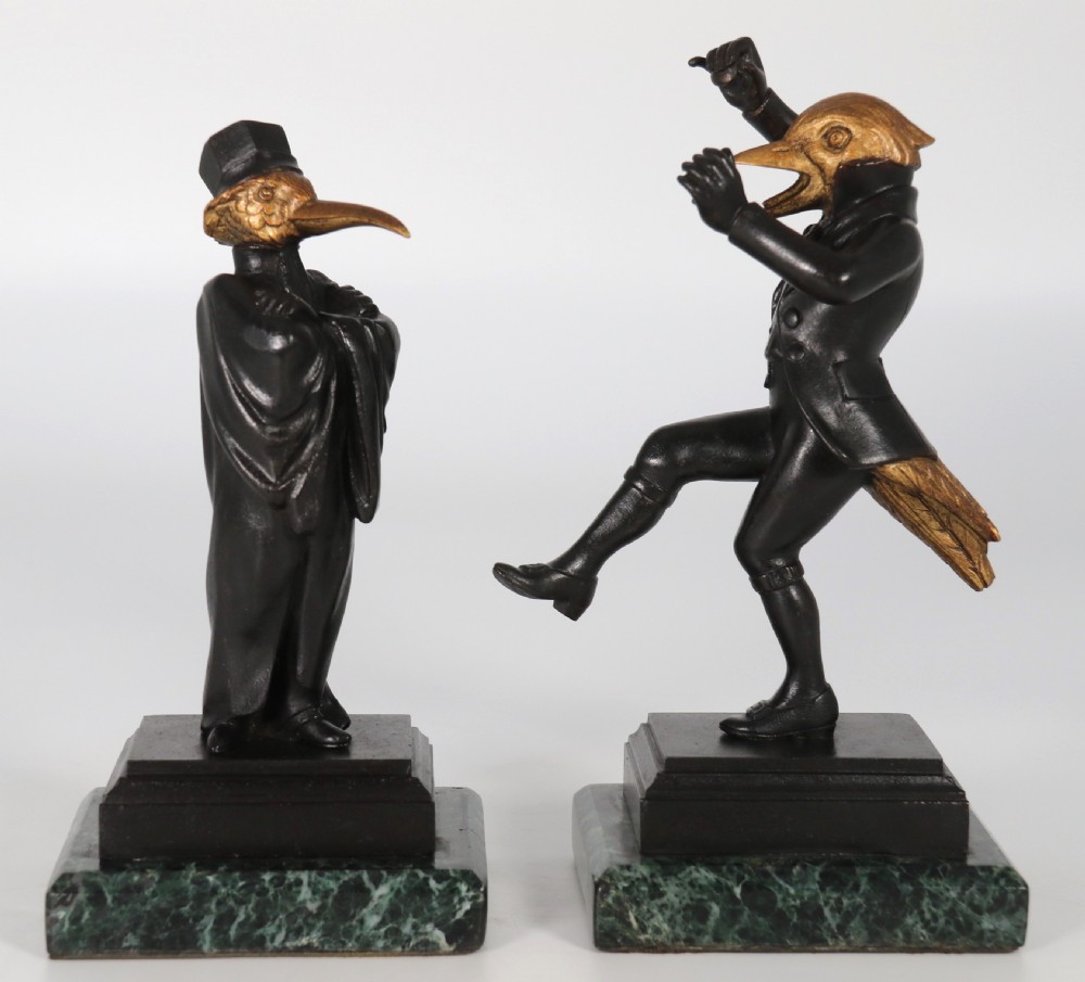 A pair of patinated and parcel-gilt bronze figures depicting anthropomorphic birds in nineteenth-century attire mounted on green marble bases. View VI