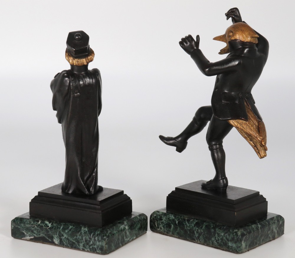 A pair of patinated and parcel-gilt bronze figures depicting anthropomorphic birds in nineteenth-century attire mounted on green marble bases. View XII