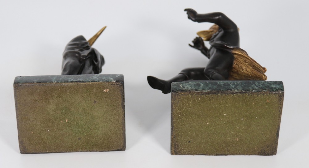 A pair of patinated and parcel-gilt bronze figures depicting anthropomorphic birds in nineteenth-century attire mounted on green marble bases. View XXIX
