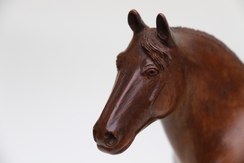 A hand-carved wooden sculpture depicting a Belgian draught horse stallion standing on an integral oval wood base. View XI