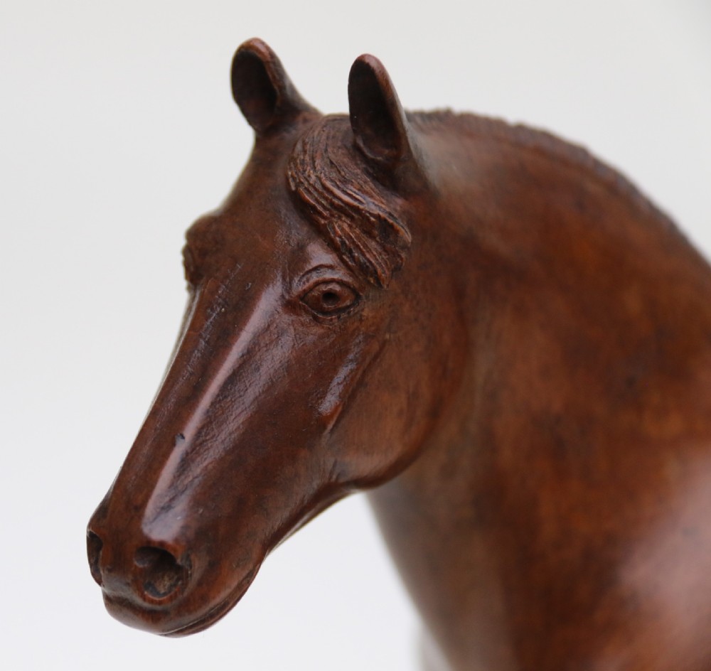 A hand-carved wooden sculpture depicting a Belgian draught horse stallion standing on an integral oval wood base. View XII
