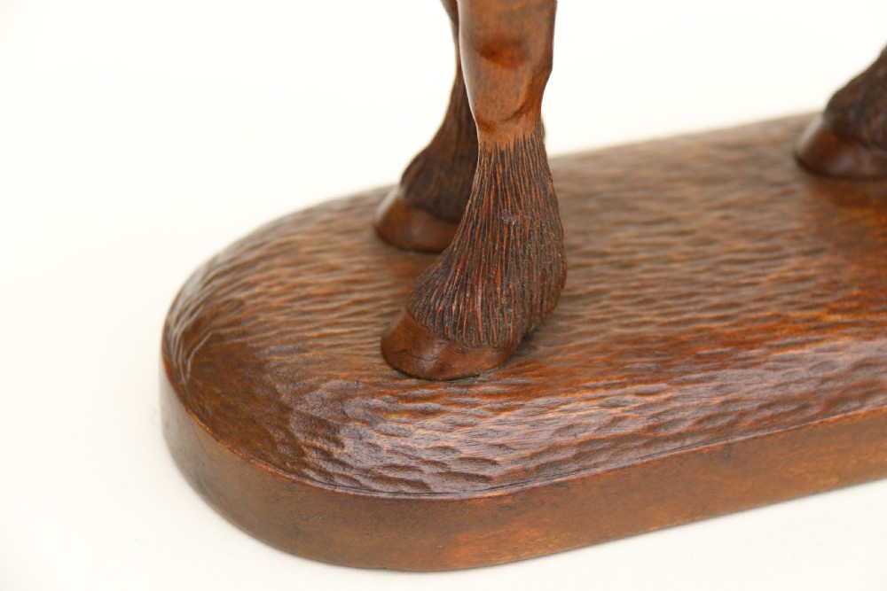 A hand-carved wooden sculpture depicting a Belgian draught horse stallion standing on an integral oval wood base. View XIII