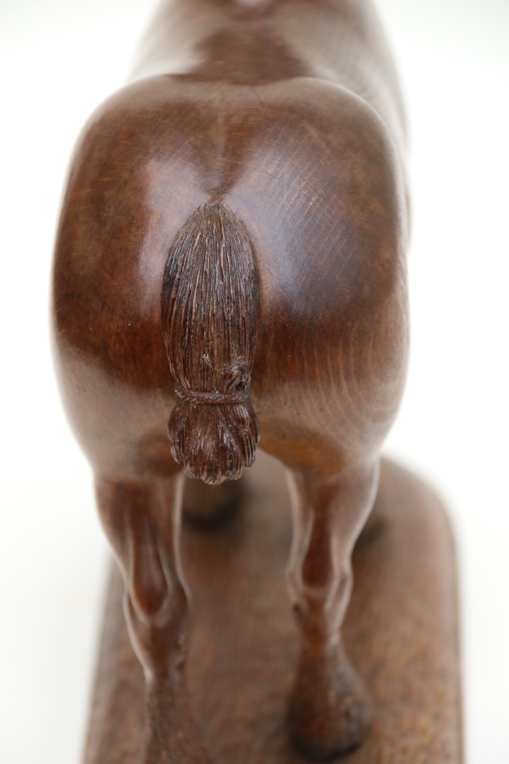 A hand-carved wooden sculpture depicting a Belgian draught horse stallion standing on an integral oval wood base. View XIV