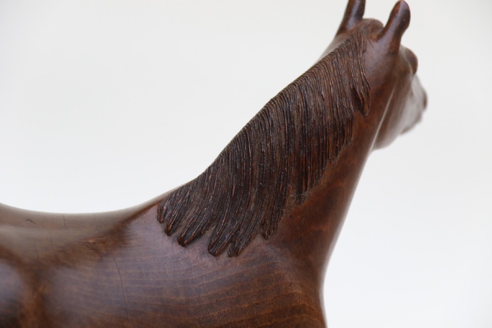 A hand-carved wooden sculpture depicting a Belgian draught horse stallion standing on an integral oval wood base. View XV