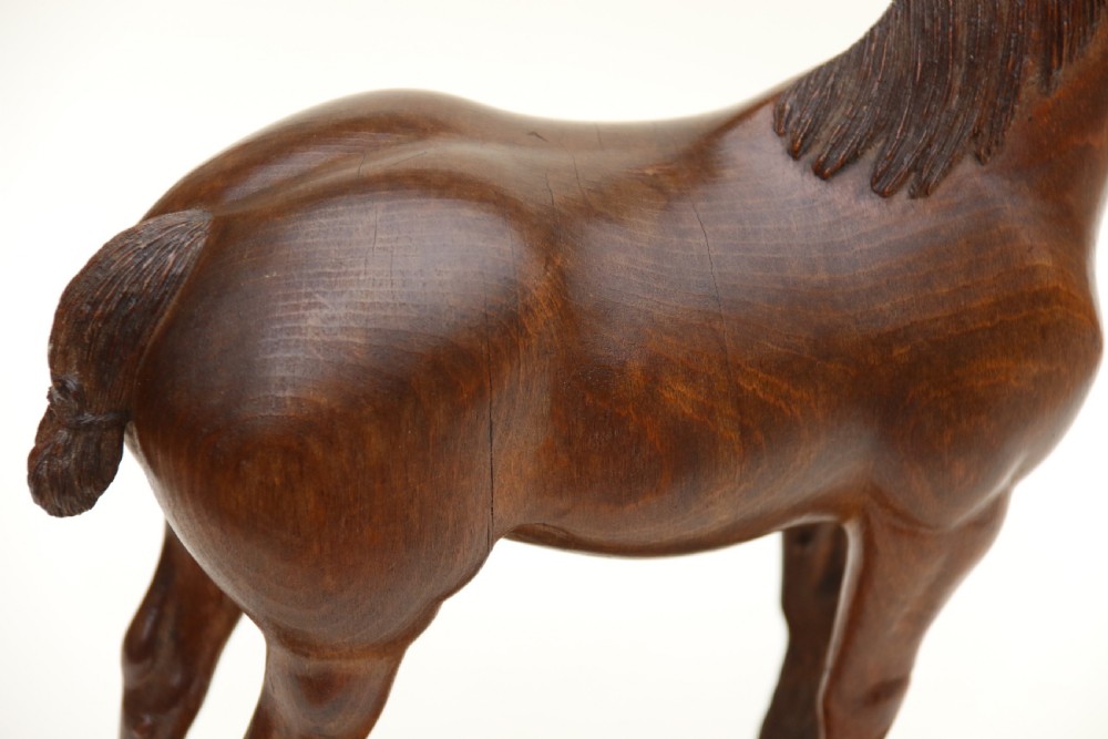 A hand-carved wooden sculpture depicting a Belgian draught horse stallion standing on an integral oval wood base. View XVI