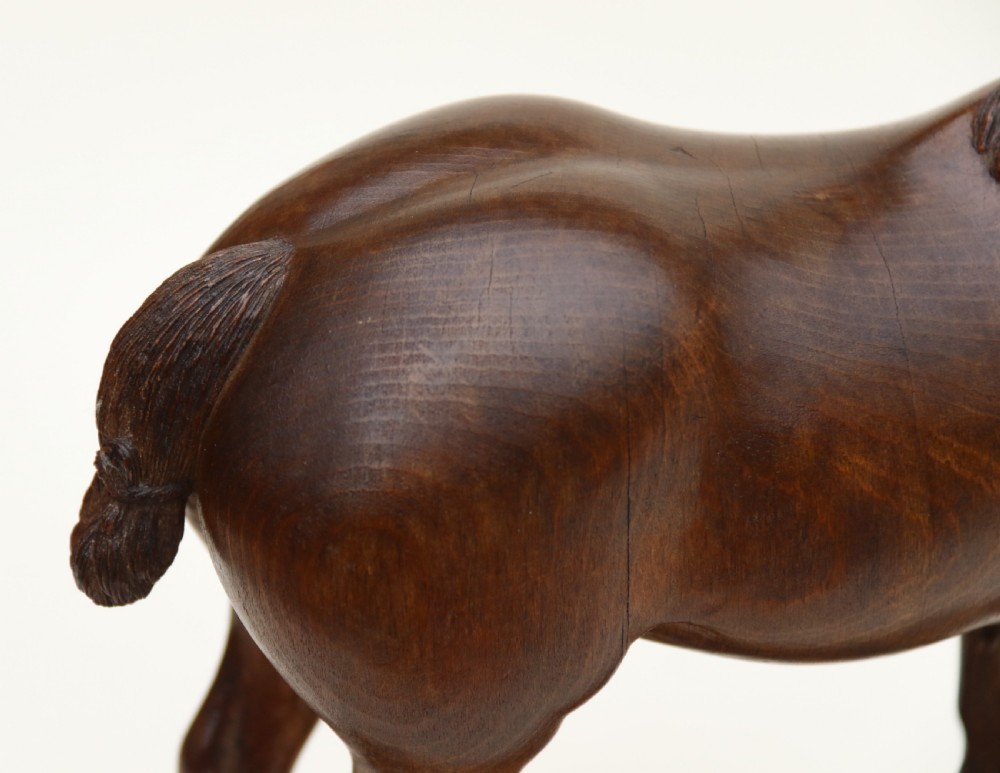 A hand-carved wooden sculpture depicting a Belgian draught horse stallion standing on an integral oval wood base. View XVII