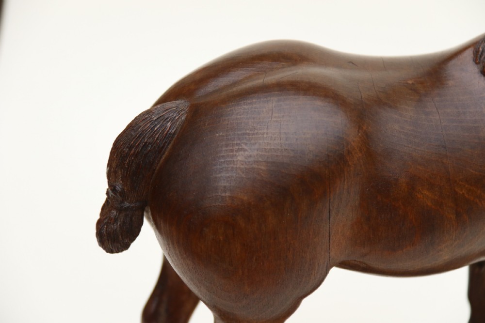 A hand-carved wooden sculpture depicting a Belgian draught horse stallion standing on an integral oval wood base. View XVIII