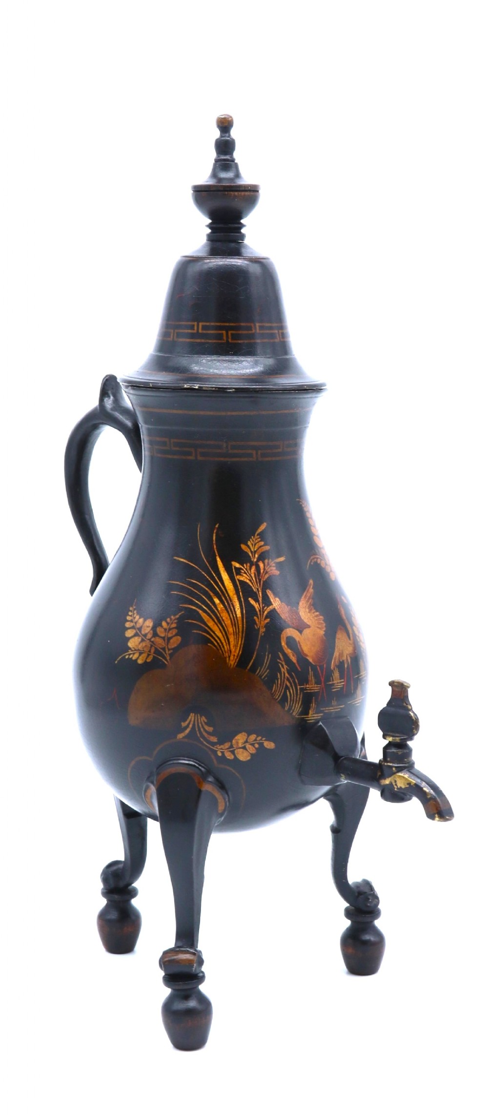 A black painted 19th-century Dutch toleware coffee urn featuring gold chinoiserie decoration, three legs, and a brass tap.