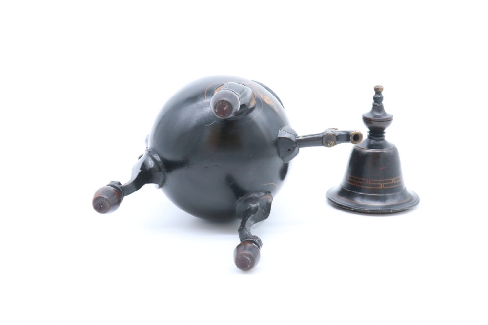 A black painted 19th-century Dutch toleware coffee urn featuring gold chinoiserie decoration, three legs, and a brass tap. View XX