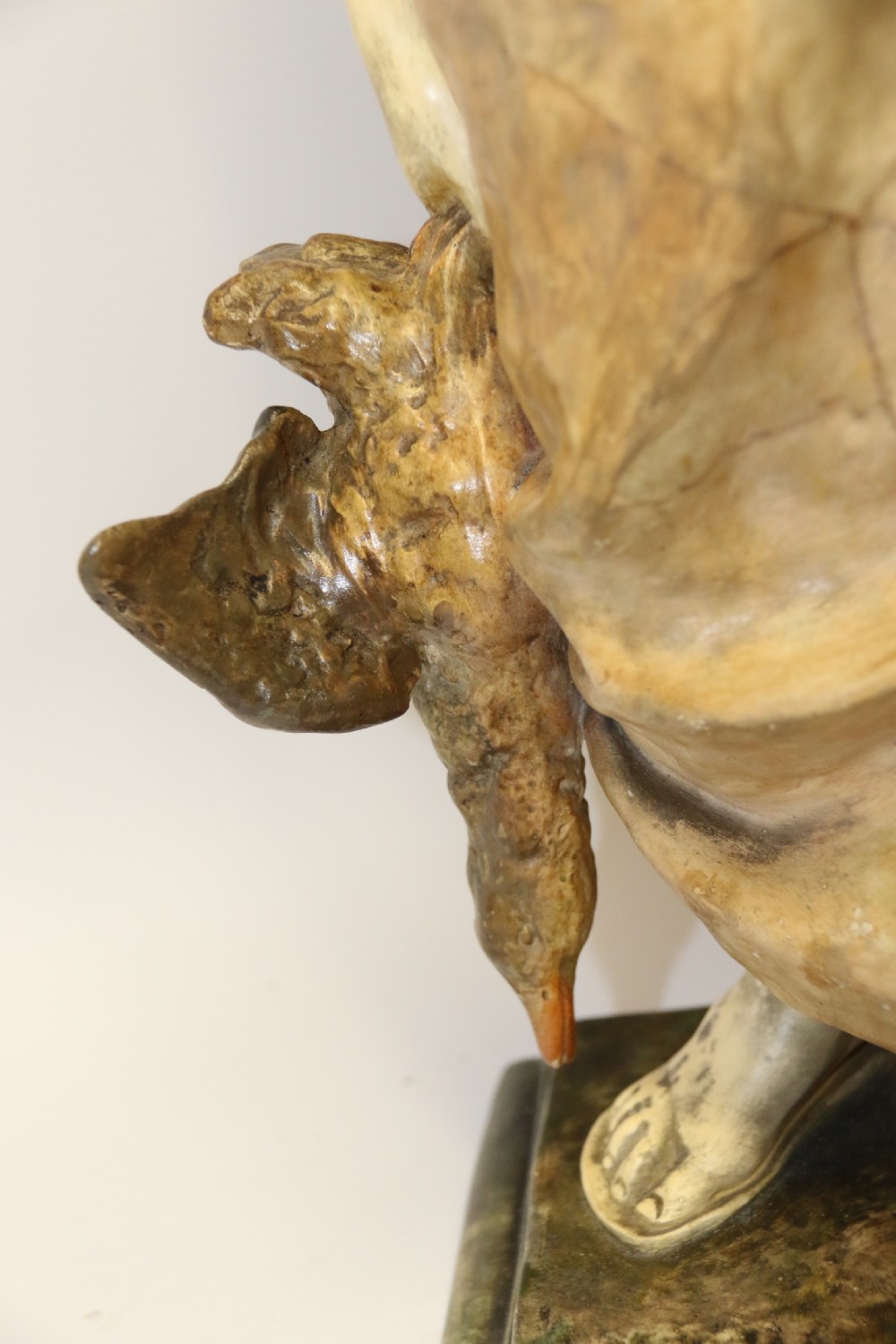 A 19th-century Goldscheider terracotta sculpture depicting a classical Roman male figure draped in robes, holding a vessel in one hand and a harvested bird in the other. View VII