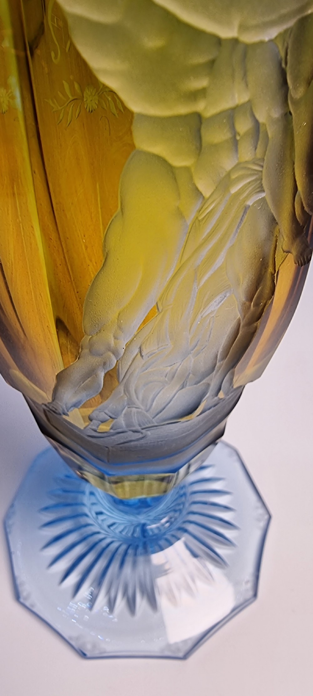 An antique Victorian amber glass goblet with wheel-engraved classical figures, supported by a light blue stem and hexagonal cut base. View XI