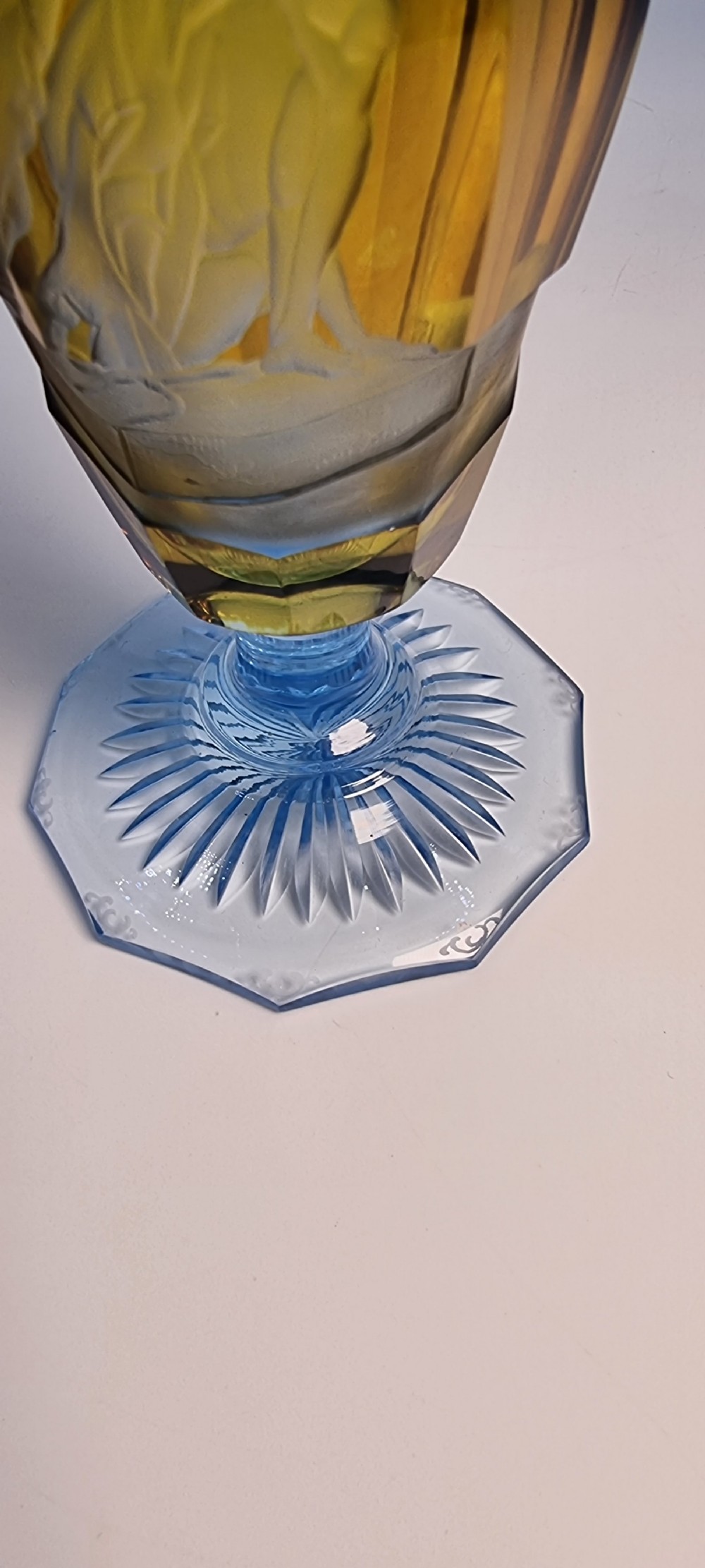 An antique Victorian amber glass goblet with wheel-engraved classical figures, supported by a light blue stem and hexagonal cut base. View XVI