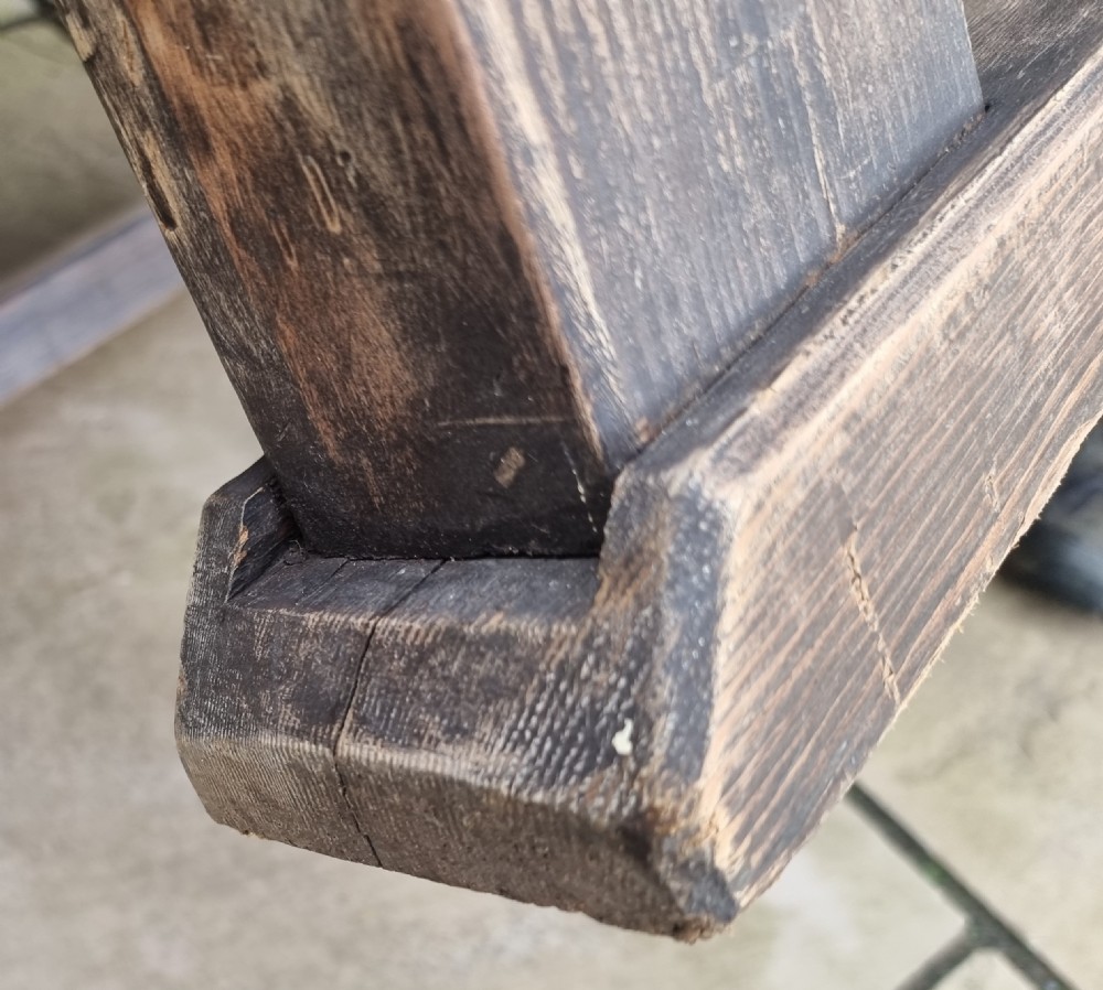 A low square rustic oak coffee table featuring a dark hand-painted geometric top and heavy timber legs. View XVII