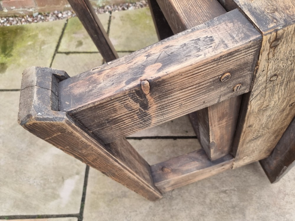 A low square rustic oak coffee table featuring a dark hand-painted geometric top and heavy timber legs. View XIX