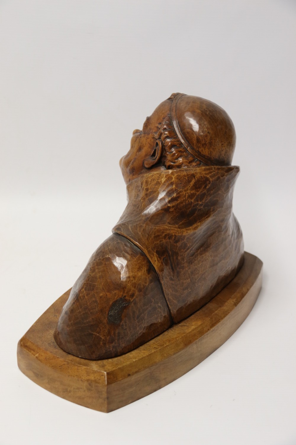 A late 19th-century hand-carved walnut study bust depicting a hooded monk on a moulded wooden base. View III