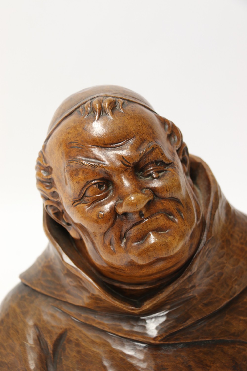 A late 19th-century hand-carved walnut study bust depicting a hooded monk on a moulded wooden base. View VI