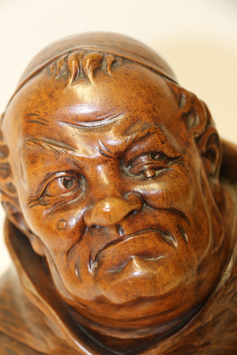 A late 19th-century hand-carved walnut study bust depicting a hooded monk on a moulded wooden base. View VIII