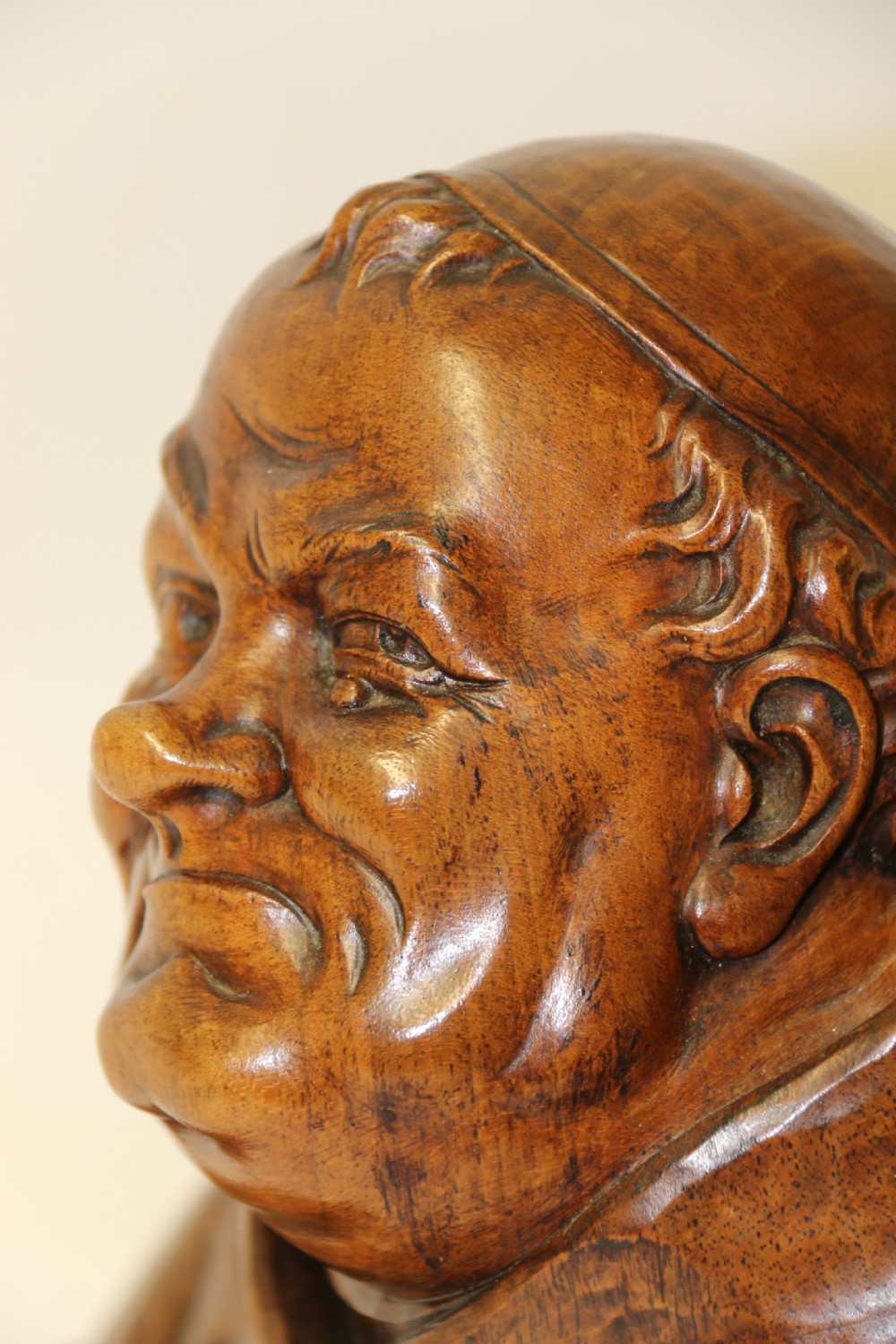 A late 19th-century hand-carved walnut study bust depicting a hooded monk on a moulded wooden base. View IX