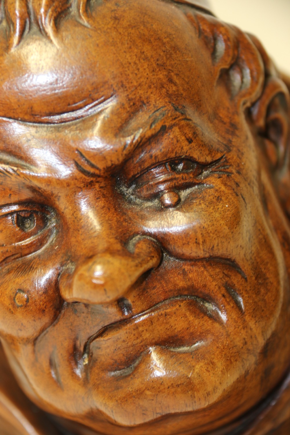 A late 19th-century hand-carved walnut study bust depicting a hooded monk on a moulded wooden base. View XII