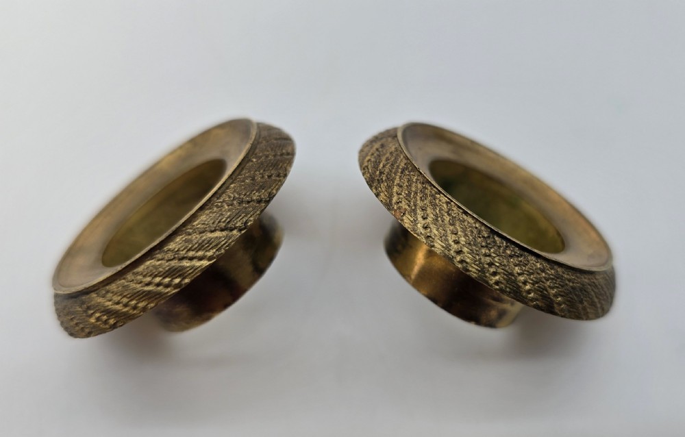 A pair of antique French Empire gilt bronze and yellow marble candlesticks featuring urn-shaped sconces, tapered rectangular pillars with floral appliques, and square bases on small ball feet. View XXVI