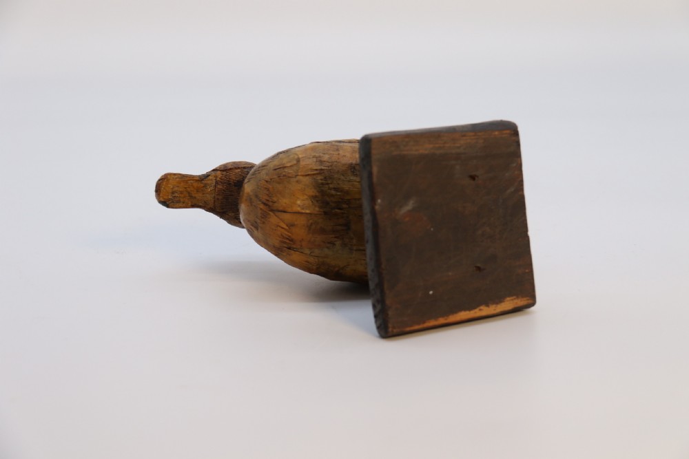 A small folk art duckling sculpture crafted from papier mache and textured straw, mounted on a square wooden base. View VI