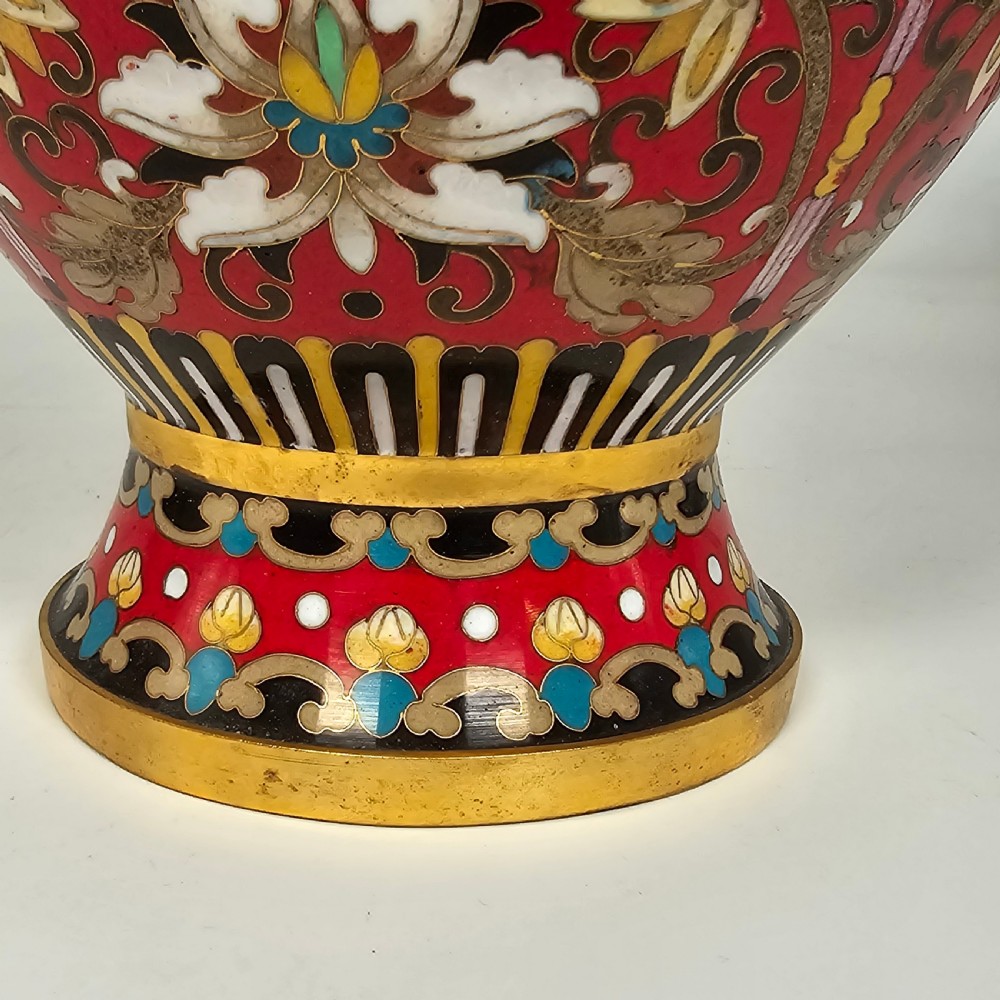 A pair of baluster-form Chinese cloisonne enamel vases featuring red backgrounds, gilded rims, floral scrolls, and character motifs. View XVII