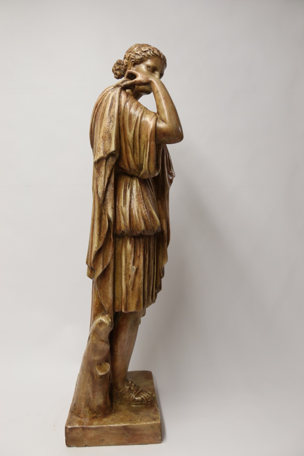 A nineteenth-century Neoclassical sculpture depicting Diana the Huntress draped in classical robes standing on a square base with a warm beige patinated finish. View IV
