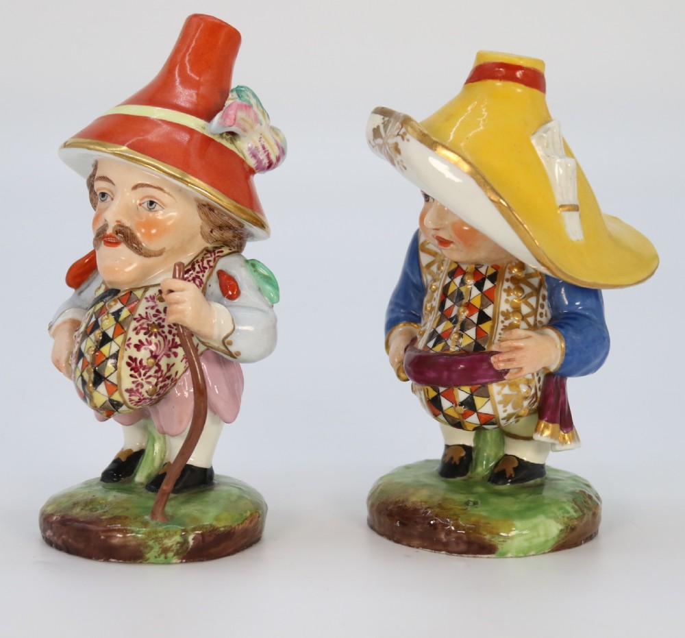 A pair of 19th-century hand-painted Samson porcelain Mansion House dwarf figurines featuring oversized hats and patterned waistcoats. View II
