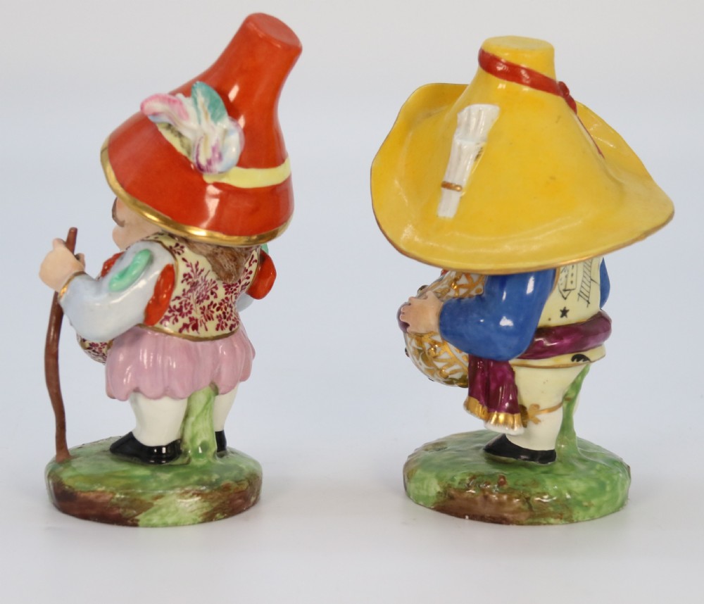 A pair of 19th-century hand-painted Samson porcelain Mansion House dwarf figurines featuring oversized hats and patterned waistcoats. View IV